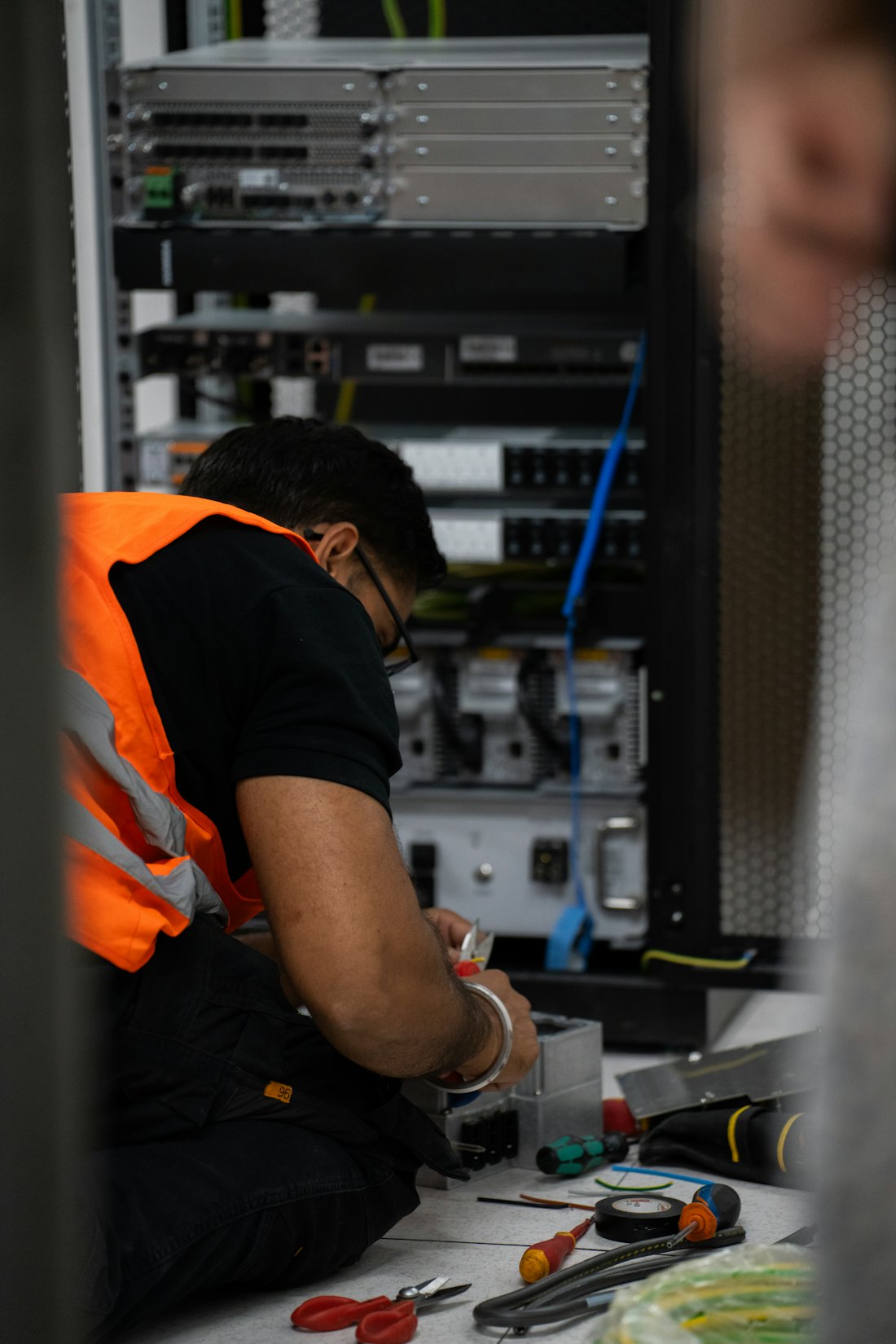 Technician servicing hardware onsite with tools